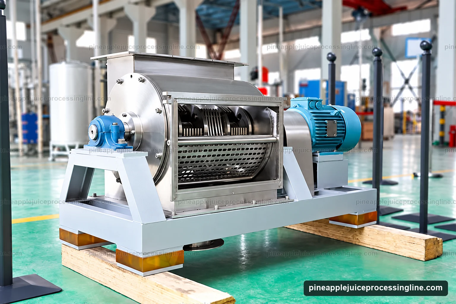 Open fruit crusher showing its hopper, working rotor, perforated screen and external drive